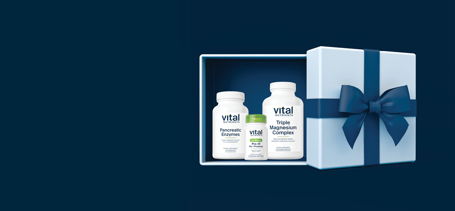 Vital nutrients supplements in a gift box with a blue ribbon on a dark blue background. Free Shipping on all orders until 12/31.