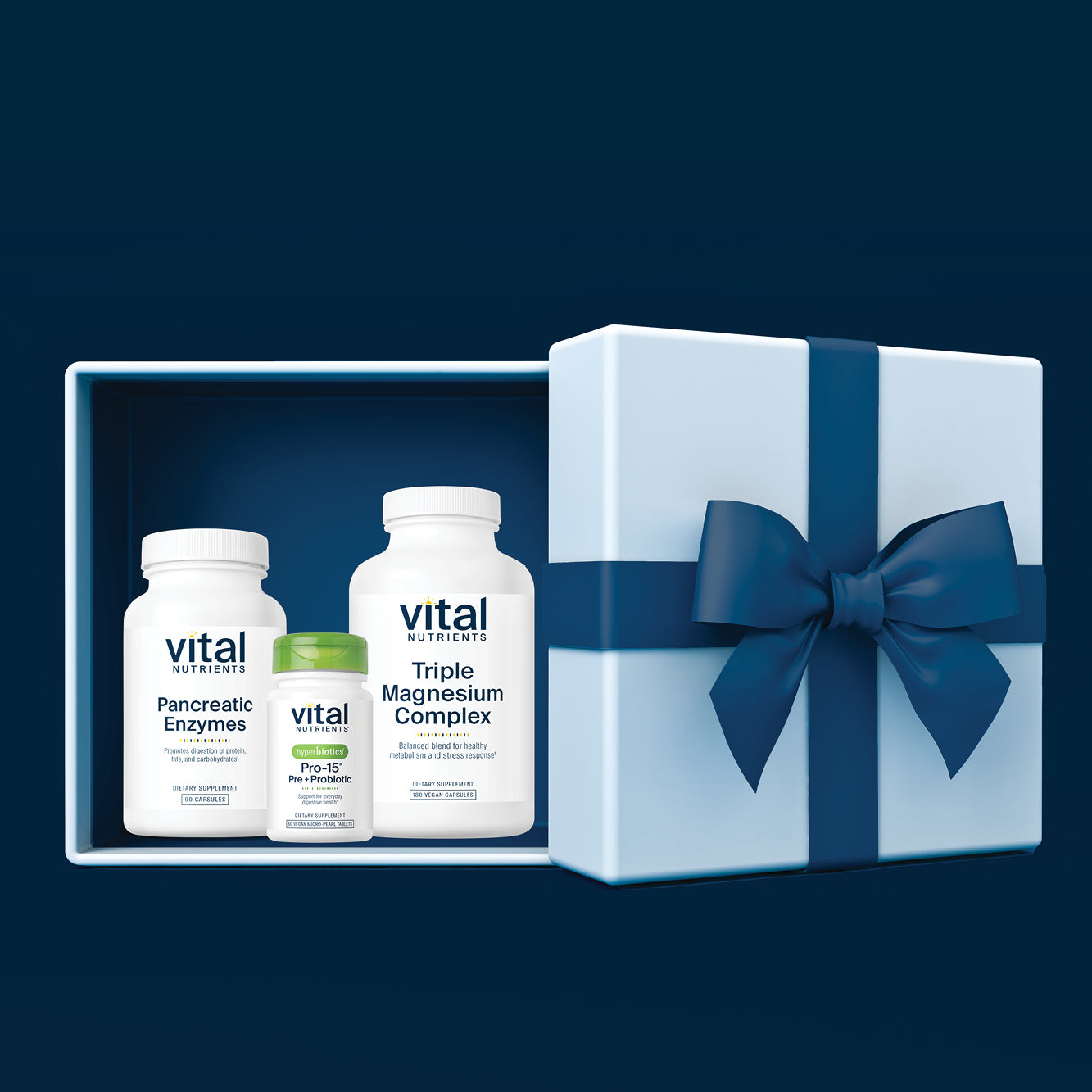Vital nutrients supplements in a gift box with a blue ribbon on a dark blue background. Free Shipping on all orders until 12/31.